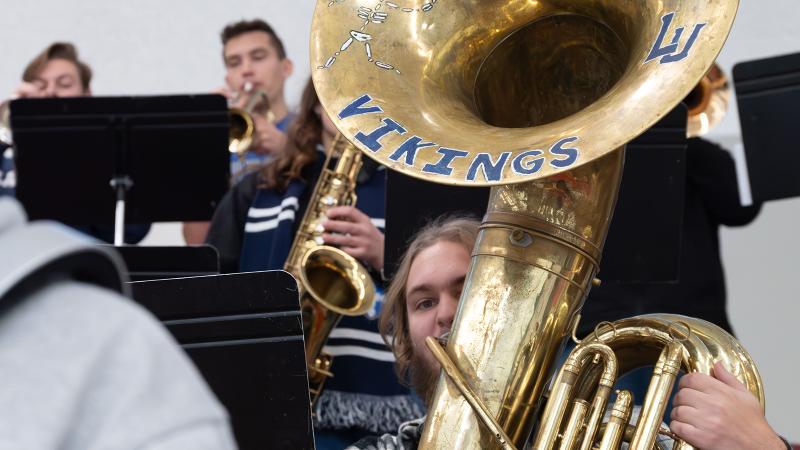 A student playing the tuba in Pep Band.