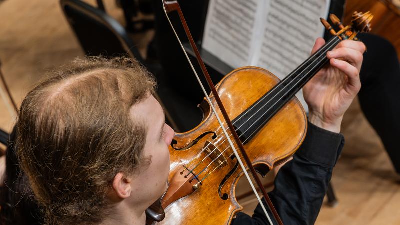 A musician playing Lawrence’s 1680s Andrea Guarneri violin.