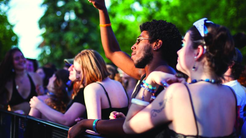 group of students dancing in a crowd at an event
