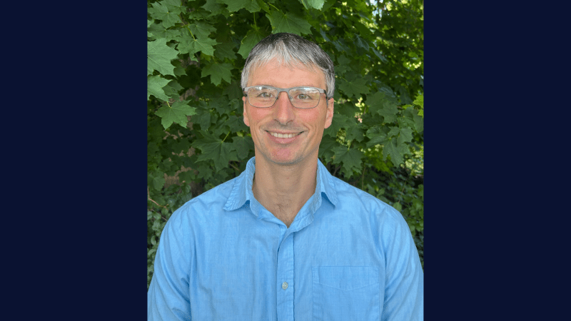 A person wearing glasses and a blue shirt