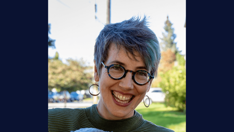 A person smiling with glasses