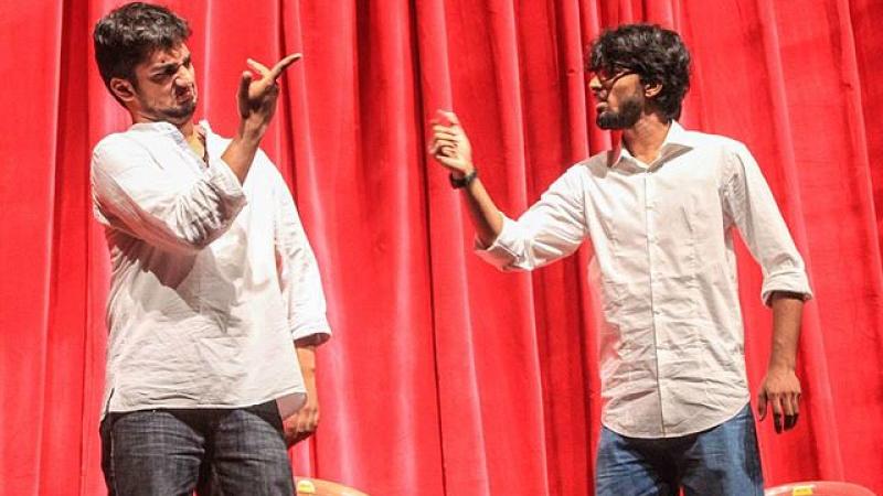 two gentlemen involved in an improvisational scene, pointing and gesturing