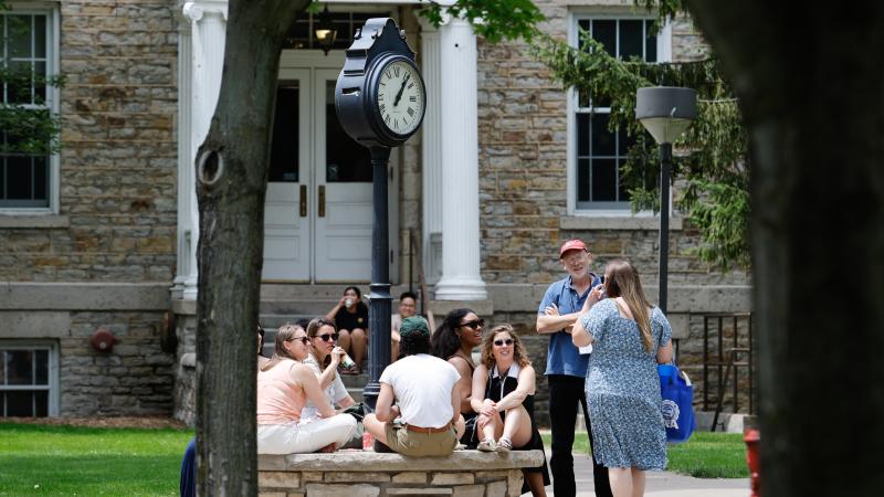 Alumni gather at the clock outside Main Hall