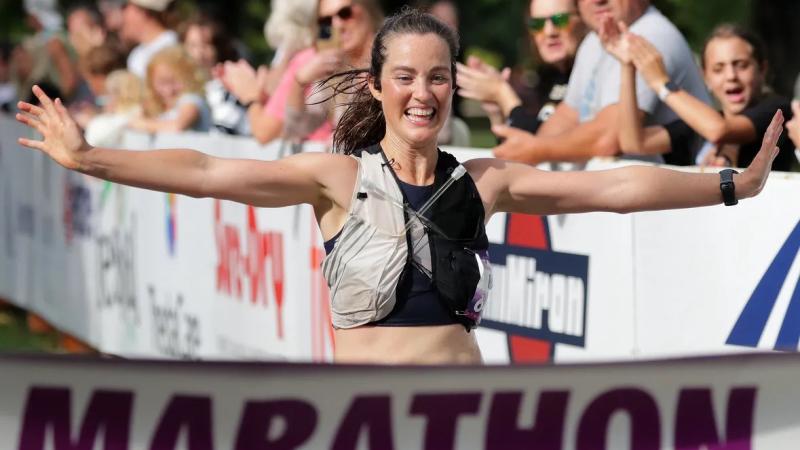 Relena Ribbons, Lawrence University's associate professor of geosciences, runs across the finsh line for victory. 