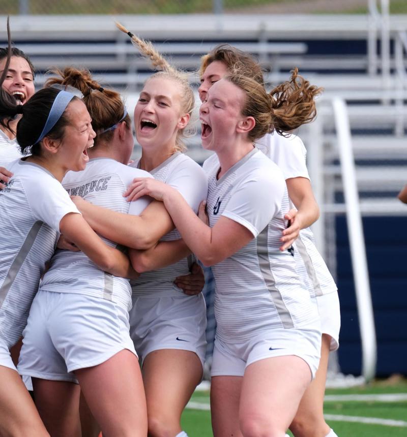 Teammates surround Lawrence University's Emma Vasconez after scoring a golden goal in overtime