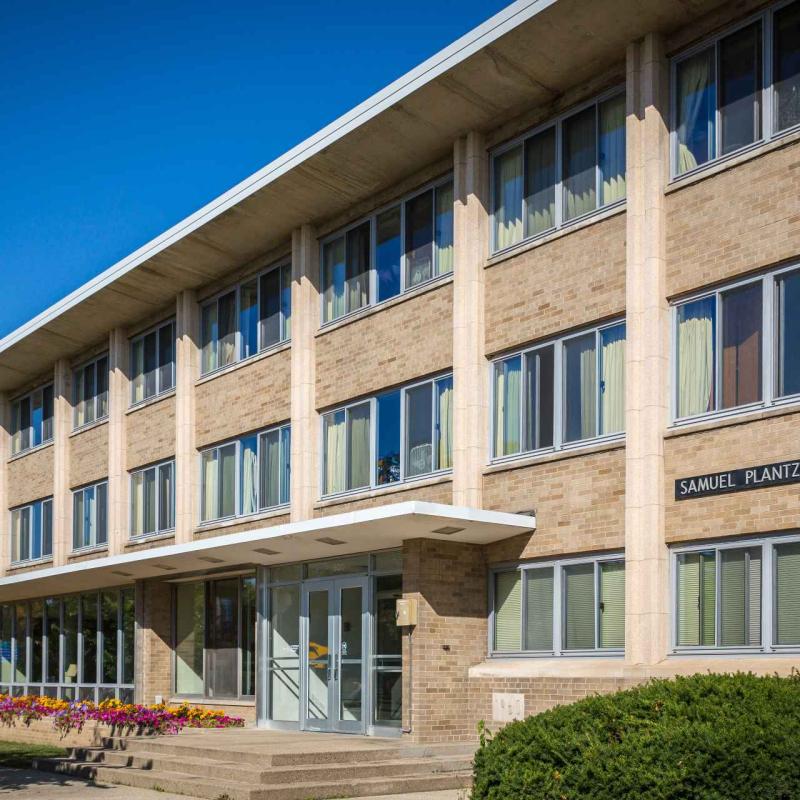 Long 3-story building against blue sky