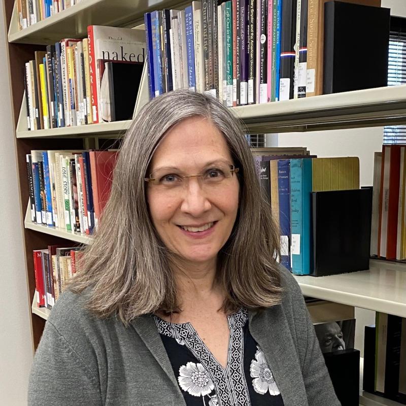 standing in front of book shelves