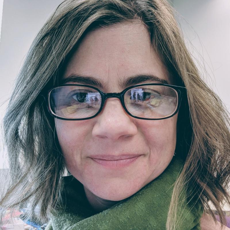 woman with glasses smiling 
