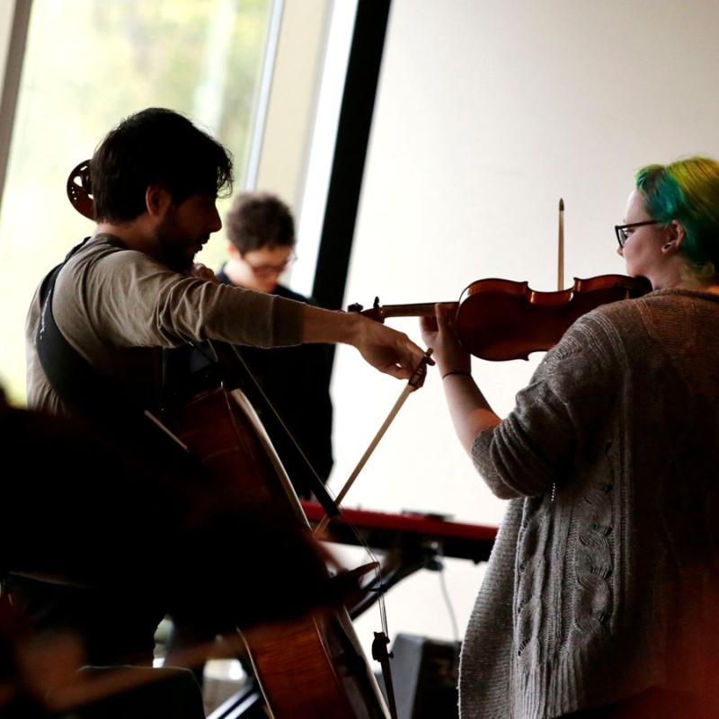 Students playing string instruments