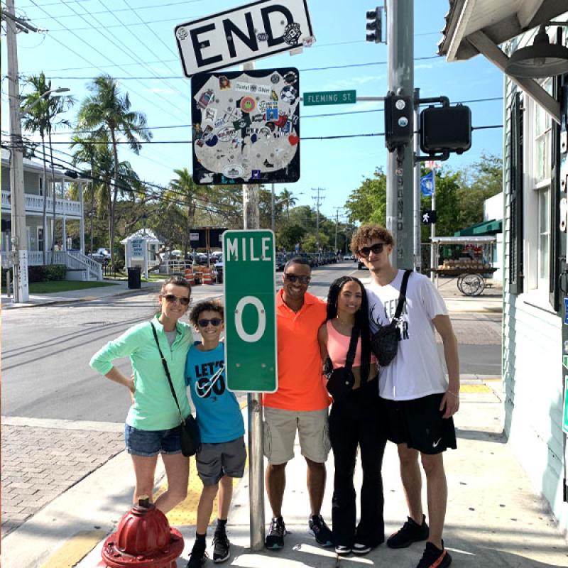 Tracy Donald '95 profile pic with family at Route 1 highway sign