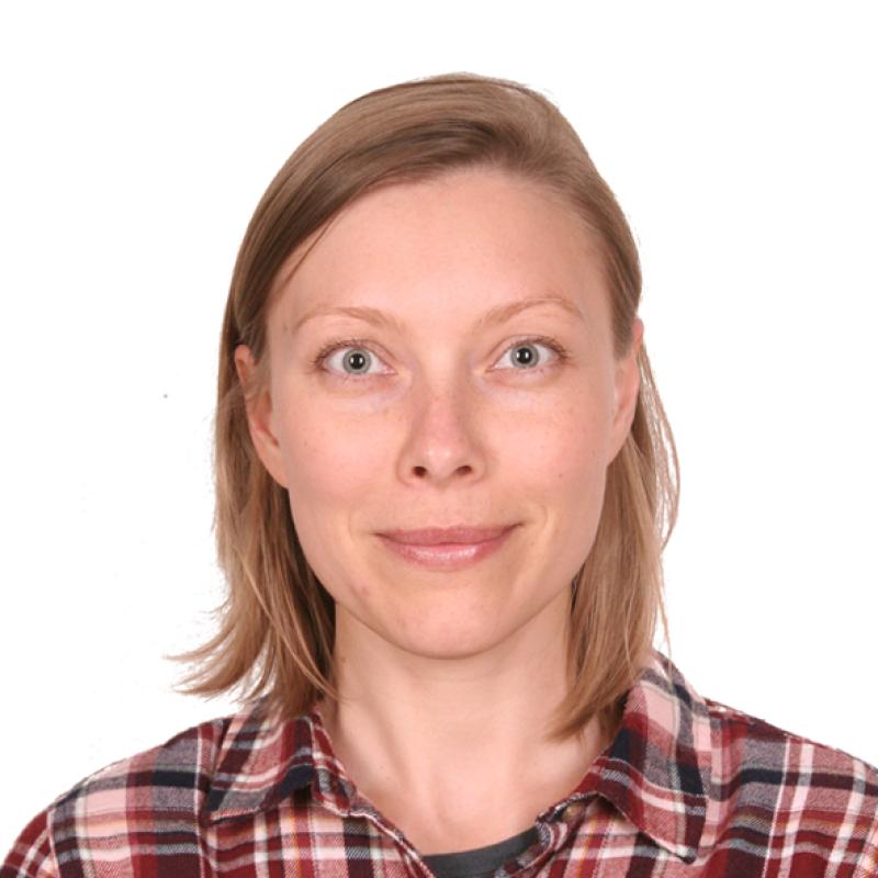 A passport photo of a woman in her late thirties of slavic appearance - white complexion, blue eyes, and shulder-long straight blond hair. She is smiling in a friendly and confident way.
