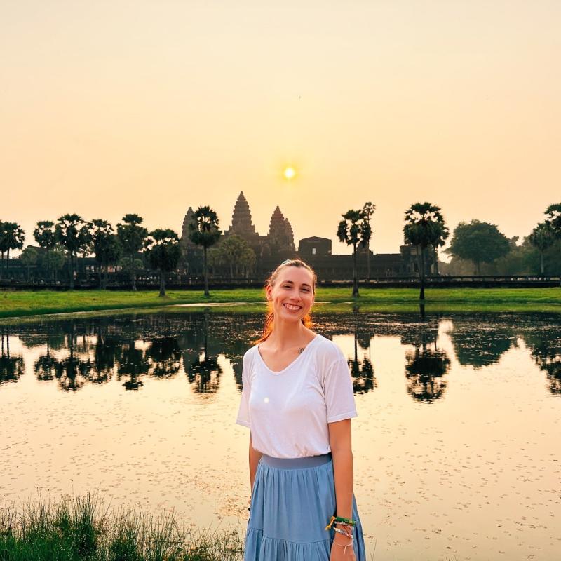 Cheyenne Koscher standing in front of Angkor Wat in Cambodia