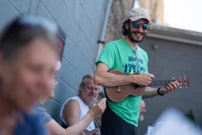 Adam Korber '18 works with the Music Education Team during the Uke Jam.
