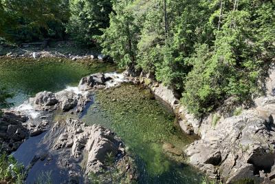 A blue-green lake is surrounded by rocks and forest.