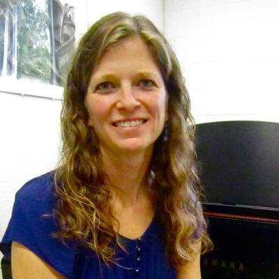 headshot of Mary Van De Loo at piano