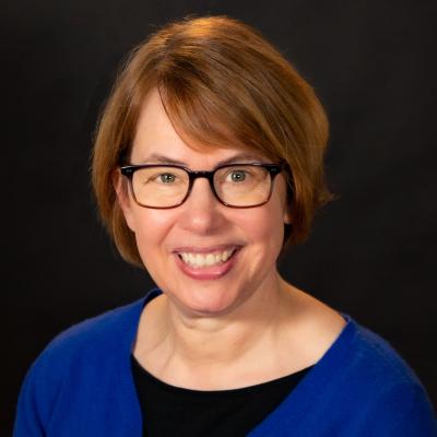 Headshot of Karen Hoffmann with dark background