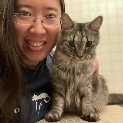 Casual headshot of Alvina Tan with a small gray cat