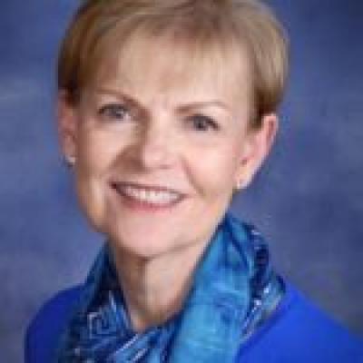 headshot of Cheryl Kopecky wearing blue, smiling