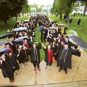 Class of 2019 students line up for commencement in the rain next to Chapel