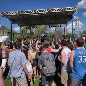 Students dancing in front of a stage while musicians perform.