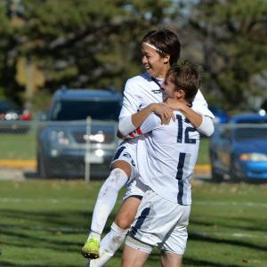Two women's soccer players hugging 