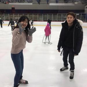Two students on ice skates in ice rink