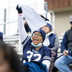Fans cheer during the football game.