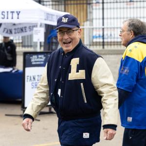 An alumnus is all smiles at the tailgate party.