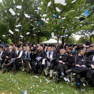 Confetti flies as graduates celebrate at the close of Commencement.