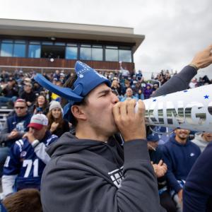 Nicolas Manzanera, a sophomore, cheers on the football team during Blue & White Homecoming Weekend.