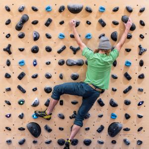 Cormac Billick, a sophomore, uses the new rock climbing wall in the Wellness Center.