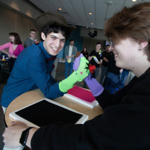 Etcetera co-presidents Eitan Price and Sam Reffug participate in Sock Puppet Arm Wrestling presented by SOUP and Etcetera in the Warch Campus Center. All donations at the event went to UNICEF.