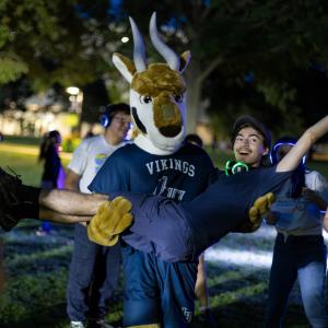 The mascot Blu holds a student for a photo during Blu’s Welcome Bash during Welcome Week.