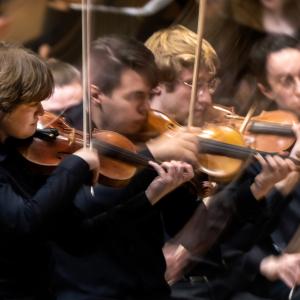 The movement of string performers can be seen during Lawrence University Choirs and Orchestra presentation of “This Love Between Us”, featuring works by Lili Boulanger, Jake Runestad, and Reena Esmail in Memorial Chapel.