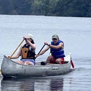 Two students canoeing on the lake - 2024 Land and Sea Pre-orientation Experience